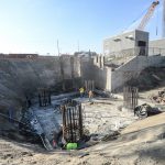 Crews prepare foundation pilings for the pile cap construction.